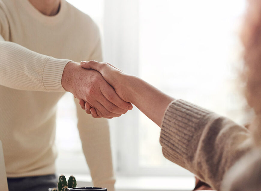 Sunlit office handshake between colleagues