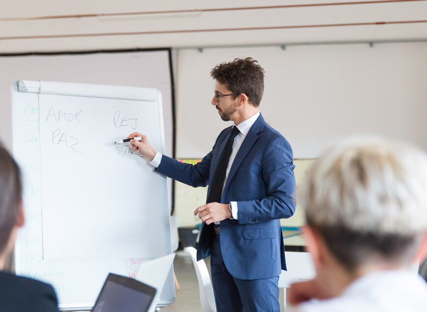 Businessman presenting at meeting with flipchart