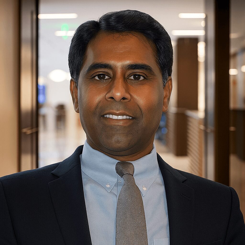 Man smiling in office hallway.