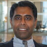 Man smiling in an office setting.